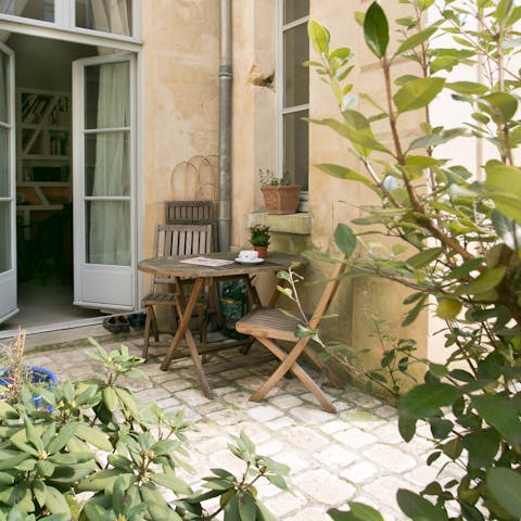 Relax with a glass of wine on the private terrace with its lush shrubs