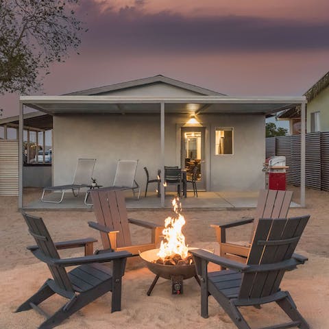 Toast marshmallows over the fire pit as twilight falls