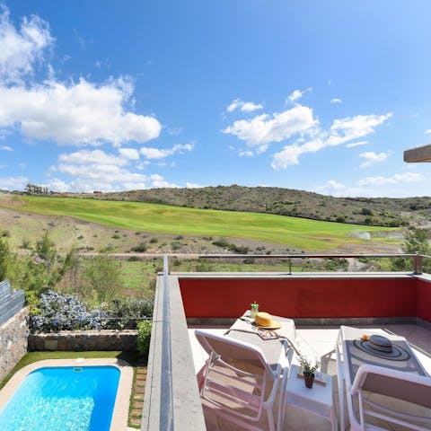 Admire the mountain and pool views from the balcony