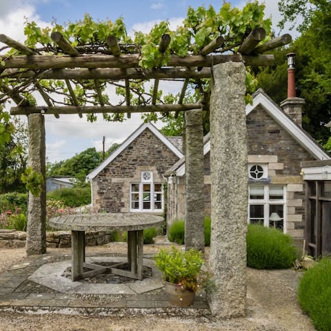 Enjoy sun-soaked summer lunches under the pergola in the garden