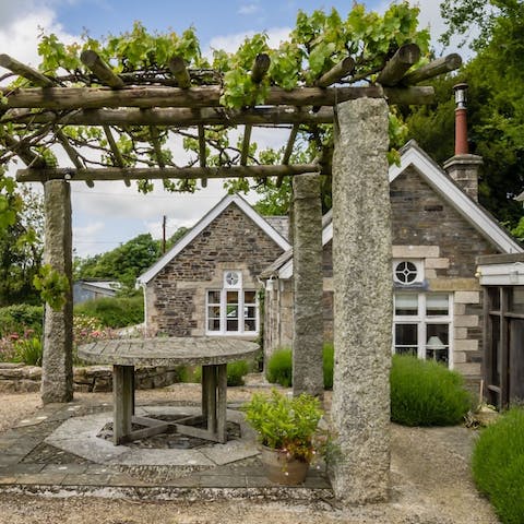 Enjoy sun-soaked summer lunches under the pergola in the garden