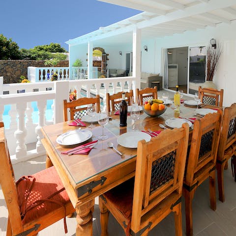 Dine alfresco in the outdoor dining area by the pool