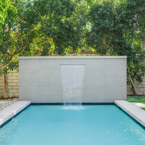 Cool off in the outdoor pool, complete with water feature