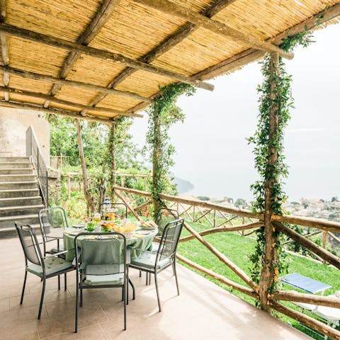 Tuck into an alfresco breakfast under the vine-wrapped pergola