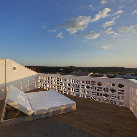 Take a glass of wine up to the terrace and enjoy the sun set over Faro