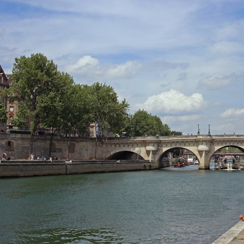Grab a coffee to go and take a stroll along the Seine River –⁠ it's just fourteen minutes away