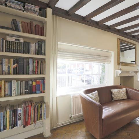 Curl up with a well-thumbed book on the leather sofa