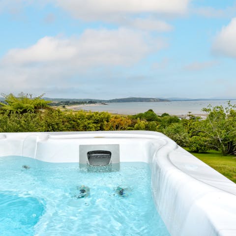 Relax in the hot tub as you admire sweeping views of the bay