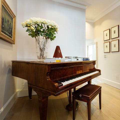 Play songs on the grand piano and fill the home with music