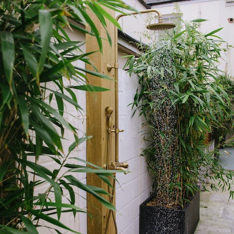 Enjoy a relaxing soak under the garden's outdoor shower