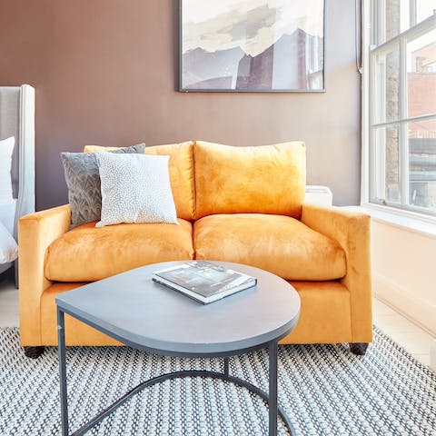 Relax with an art catalogue on the plumpy velvet sofa