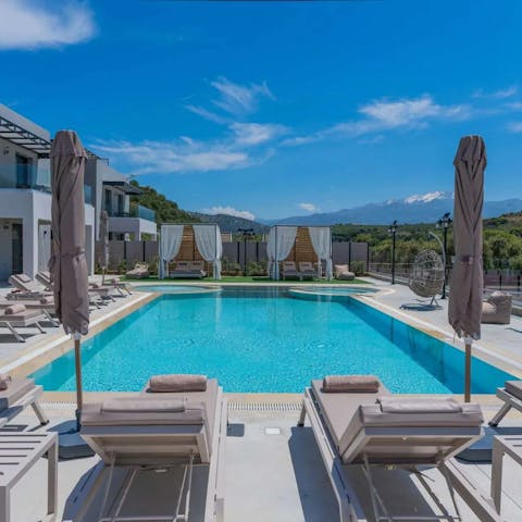 Soak up the sun by the large private pool in the shade of the umbrellas