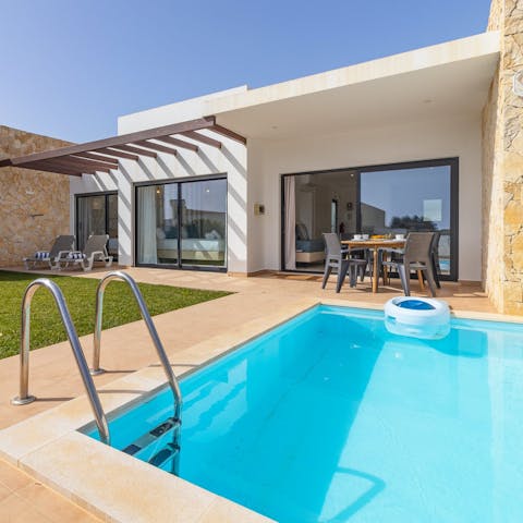 Cool off from the Algarve sun in the pool after reading on a sun lounger