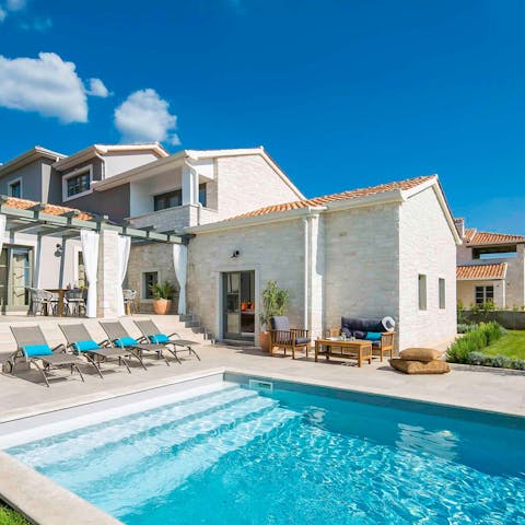 Step out of the private pool and find a sun lounger with your name on it