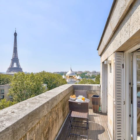 Admire the incredible views of the iconic Eiffel Tower from the private balcony