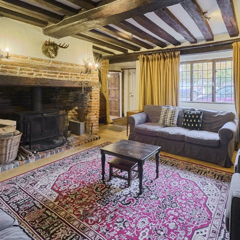 Curl up around the fireplace beneath wooden beams for a cosy night in