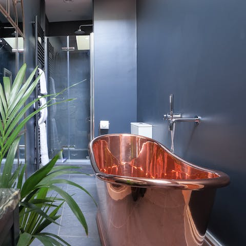 Treat yourself to an indulgent soak in the freestanding copper bathtub