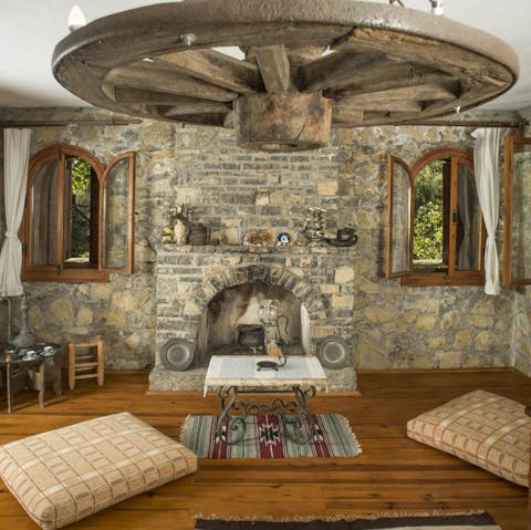 Cuddle up in front of the hearth and fall in love with this rustic, storybook cottage