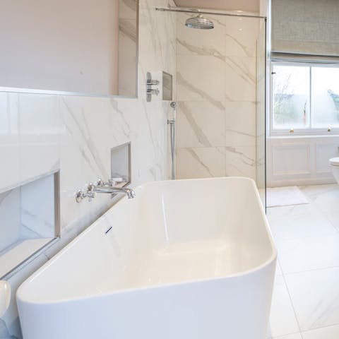 Soak in the deep bathtub and rinse off in the marble tiled shower