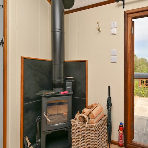 Stay toasty and warm next to the rustic wood-burner inside the hut