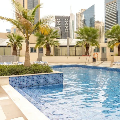 Swim in the communal pool, surrounded by skyscrapers