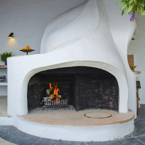 Warm up around the Gaudi-inspired fireplace