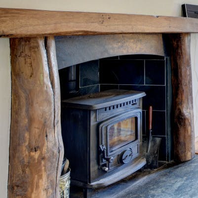 Cosy up by the wood-burning stove on chilly evenings