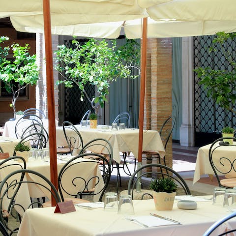 Dine like a local in the courtyard restaurant in your building