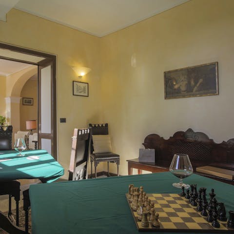 Set up a game of chess or round of poker in the games room