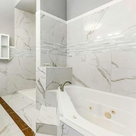 Feel like a queen in this luxurious, marbled bathroom, completed with a jacuzzi