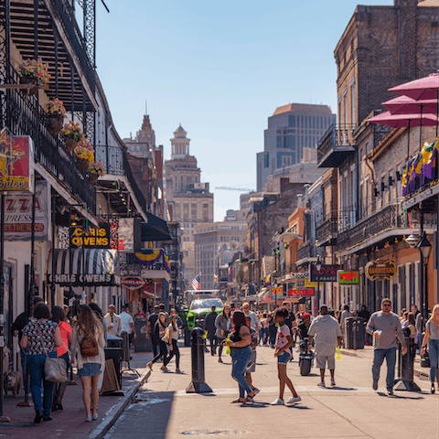Dance along the neon-lit streets of Bourbon Street, located in the heart of the French Quarter, just a twenty-seven minute walk from the house