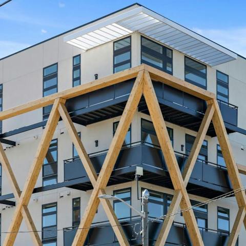 Admire the striking exterior of the building, with its timber facade design