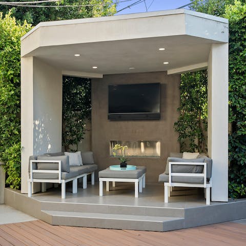 Host a movie night under the cabana, the fire crackling away