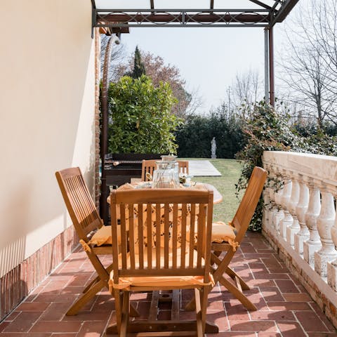Sit down to an alfresco meal while admiring the lush shared garden