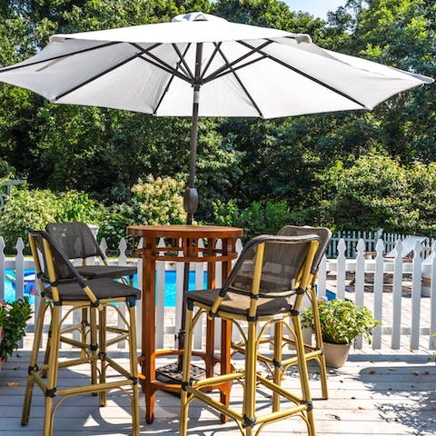 Sip on a glass of wine while you soak up the sunshine on the alfresco dining set