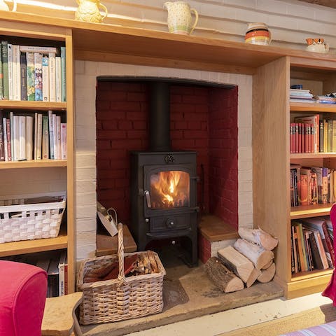 Add a log to the stove and pick a book from the library