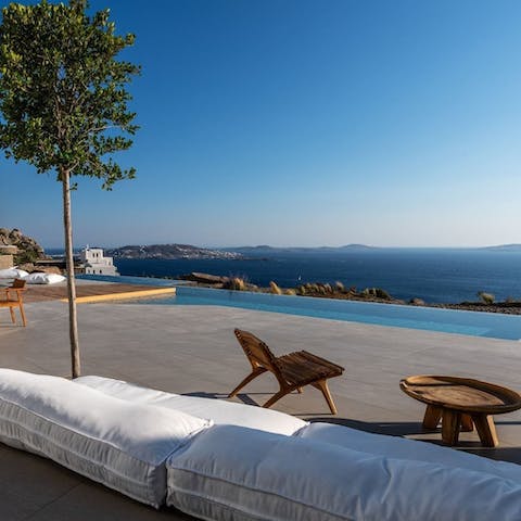 Savour idyllic views while relaxing by the pool