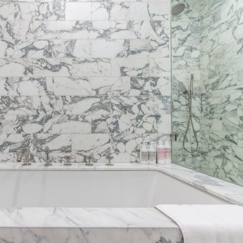 Take a well-earned soak in the luxurious, marble bathtub