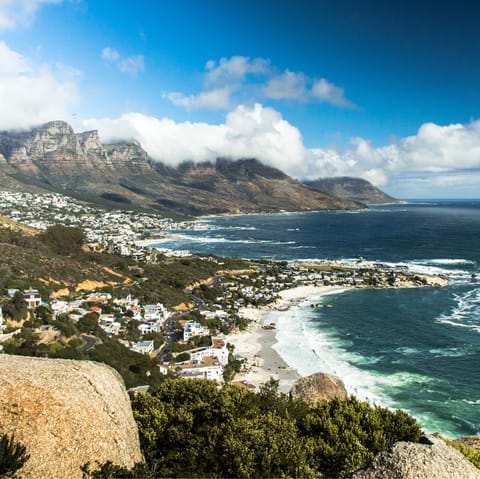 Sink your toes into the sand at Camps Bay, a mere ten-minute drive away