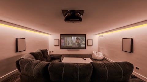 Sink into the sofas for a movie night in the home cinema room