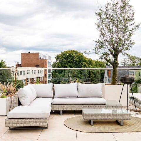 Unwind on the roof terrace, a glass of wine in hand