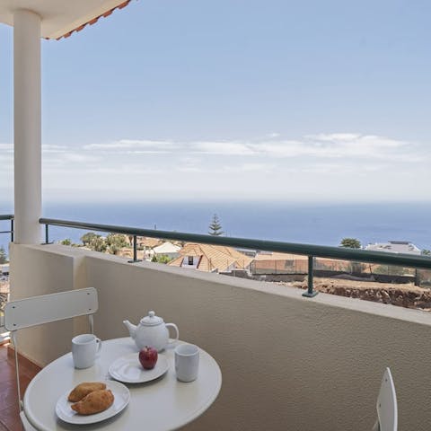 Enjoy the Atlantic Ocean vistas with a glass of Madeira on the private balcony