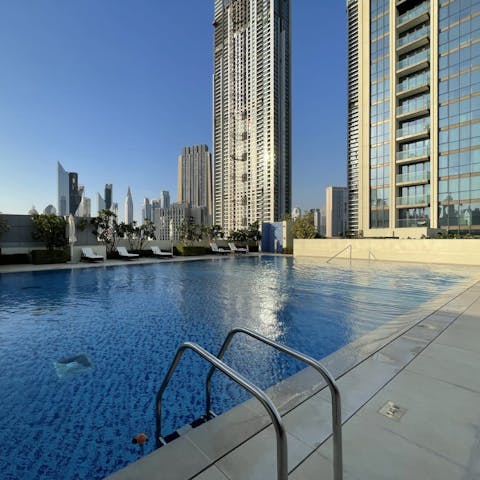 Swim in the communal pool as the Dubai sun warms your skin