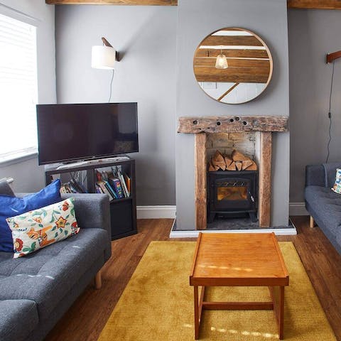 Watch a film while staying cosy next to the wood-burning fireplace