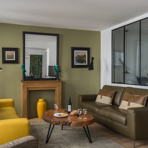 Enjoy a wine and cheese night in the calming green-toned living room