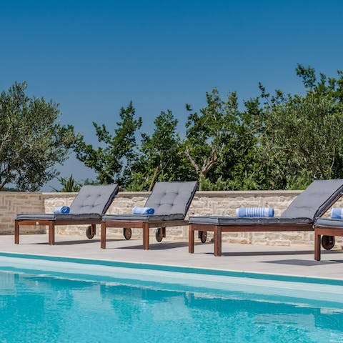 Lie back and relax on a lounger before enjoying a dip in the pool