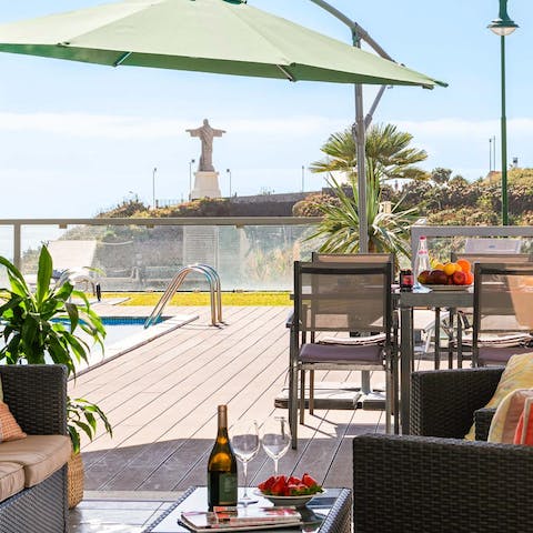 Sip wine on the patio in view of the Cristo Rei statue