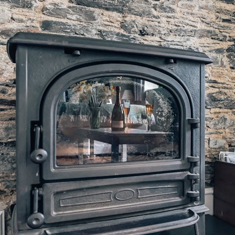 Help yourself to logs and spark up the cosy wood-burning stove