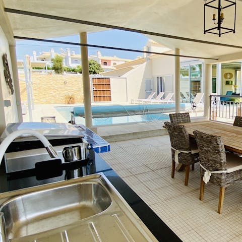 Enjoy quality time together over a meal by the pool, prepared in the outdoor kitchen