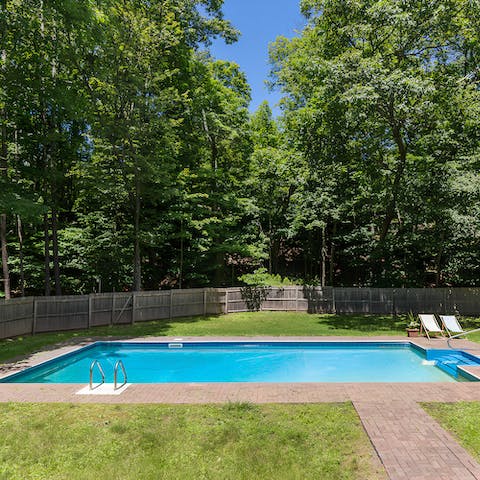 Take a dip in the pool, surrounded by mature oak and pine trees